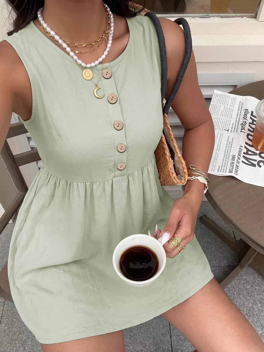 Green cotton A-line dress with button detail and gathered waist.