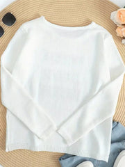 White knit sweater with crew neck, long sleeves, and side slits.