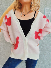 Blush pink acrylic cardigan with playful red floral appliqué, button front, and cream trim.