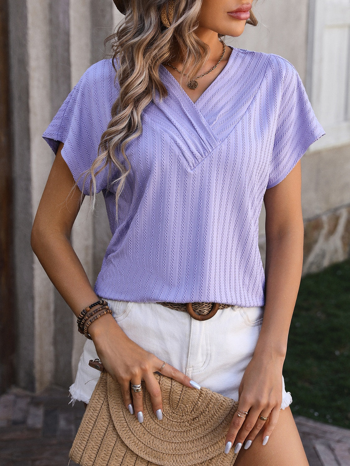 Lavender textured surplice v-neck tee with short sleeves.