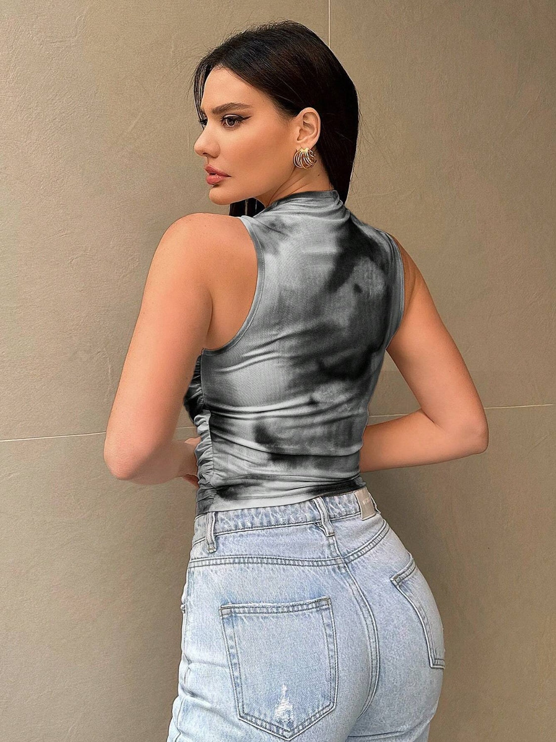 Sleeveless gray tie-dye mock neck top with ruched sides.