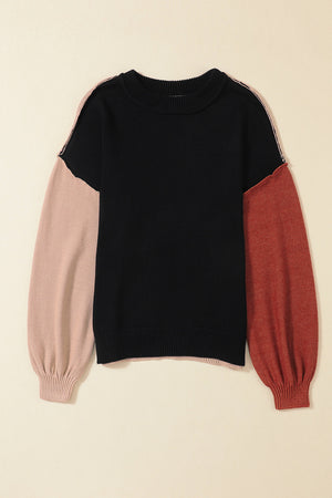 Black sweater with contrast blush pink and rust balloon sleeves, crew neck, ribbed cuffs.