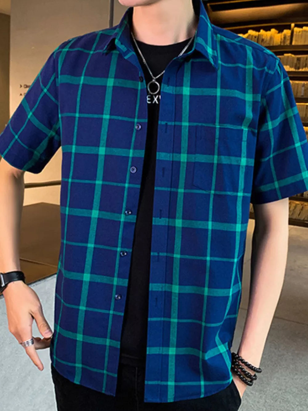 Men's blue and green plaid short sleeve button-down shirt with chest pocket.