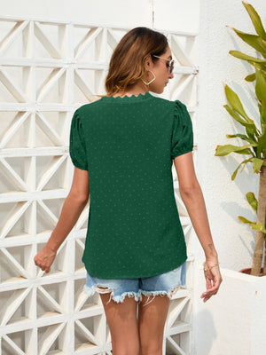 Dark green dotted Swiss blouse with puff sleeves and lace trim neckline.