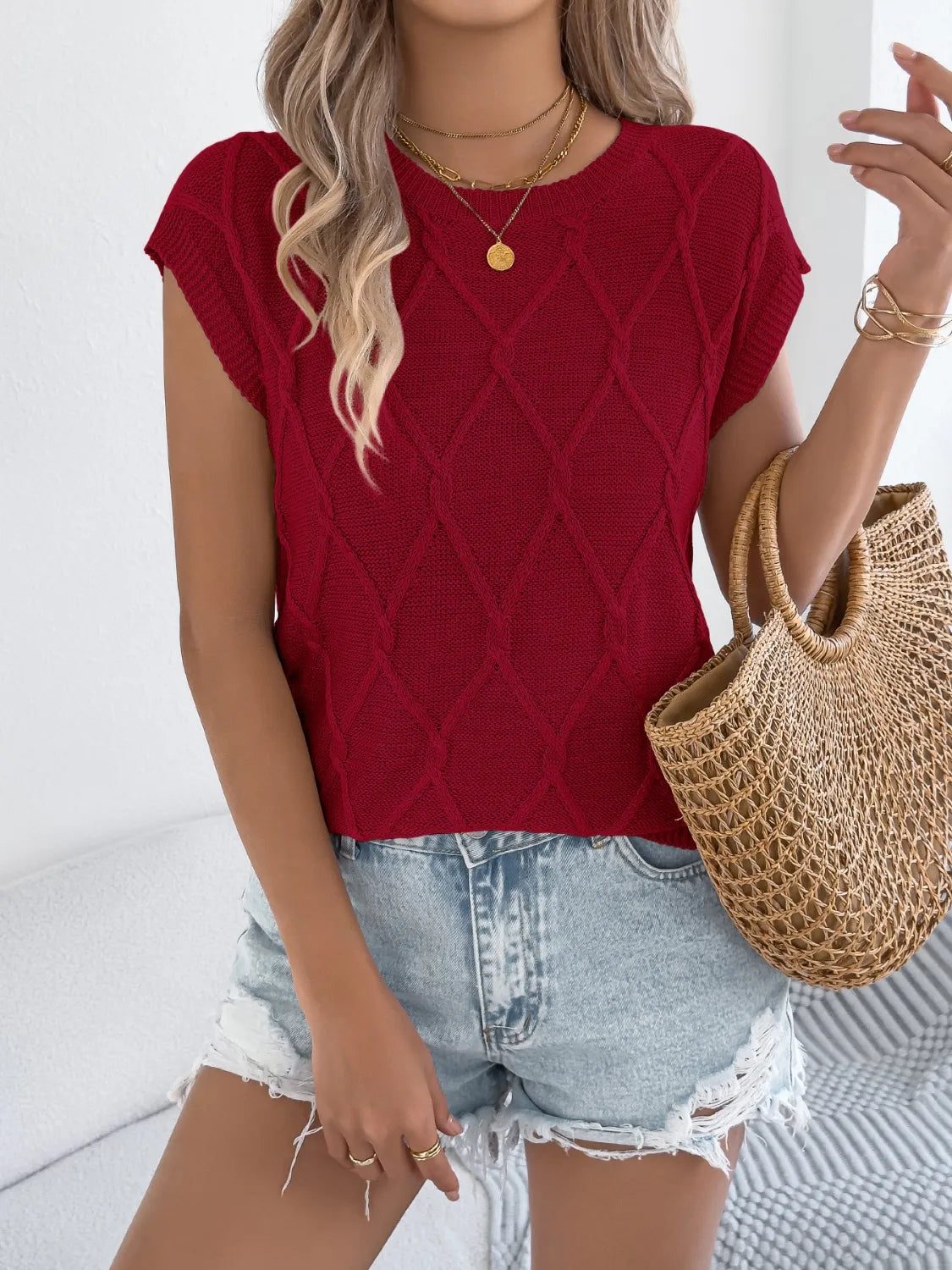 Diamond knit sleeveless top in burgundy with a crew neck.