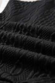 Black textured knit loungewear fabric with cable and diamond patterns.