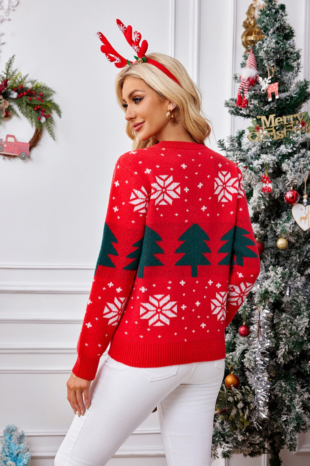 Red acrylic crewneck sweater with white snowflakes and green Christmas trees, long sleeves.