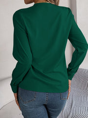 Dark green long sleeve blouse with V-neckline and button cuffs.
