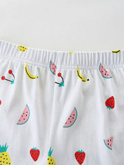 Baby shorts with elastic waist and allover fruit print including watermelon, banana, cherry, strawberry, and pineapple.