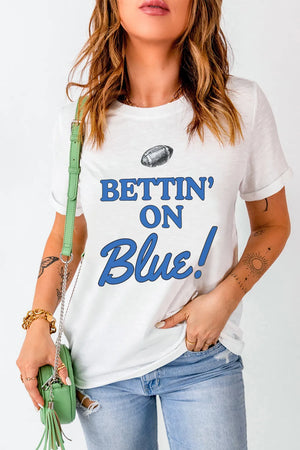 White graphic t-shirt with blue text that says Bettin' On Blue! and a football graphic.
