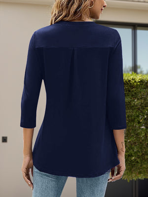 Navy V-neck three-quarter sleeve top with back pleat detail.