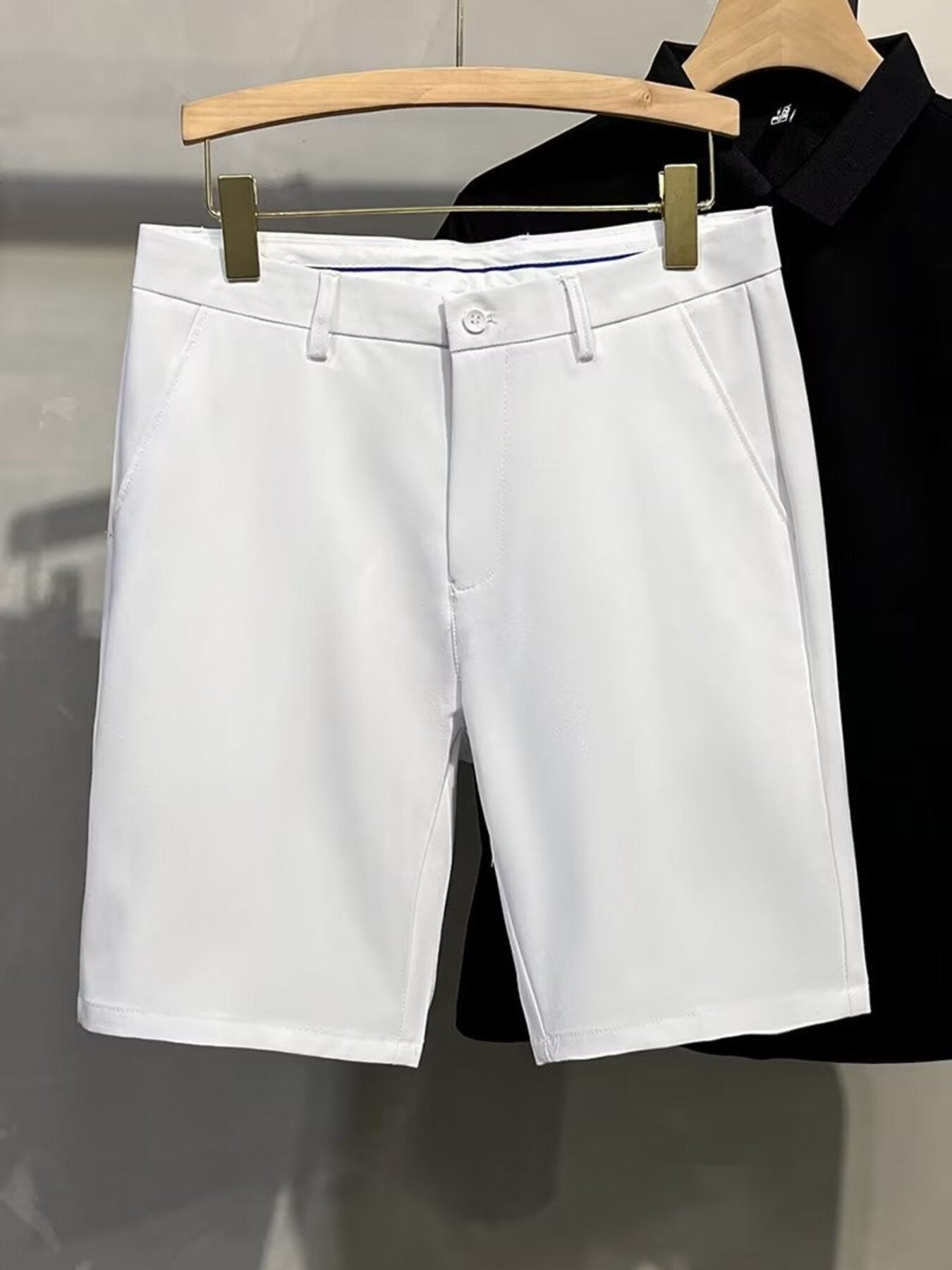 Men's white chino shorts with a button and zip fly, classic fit.