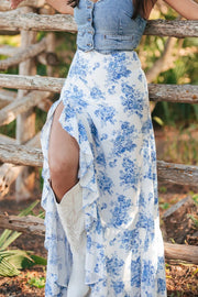 Toile print asymmetric ruffle skirt in light blue with a high slit and ruffled hem.