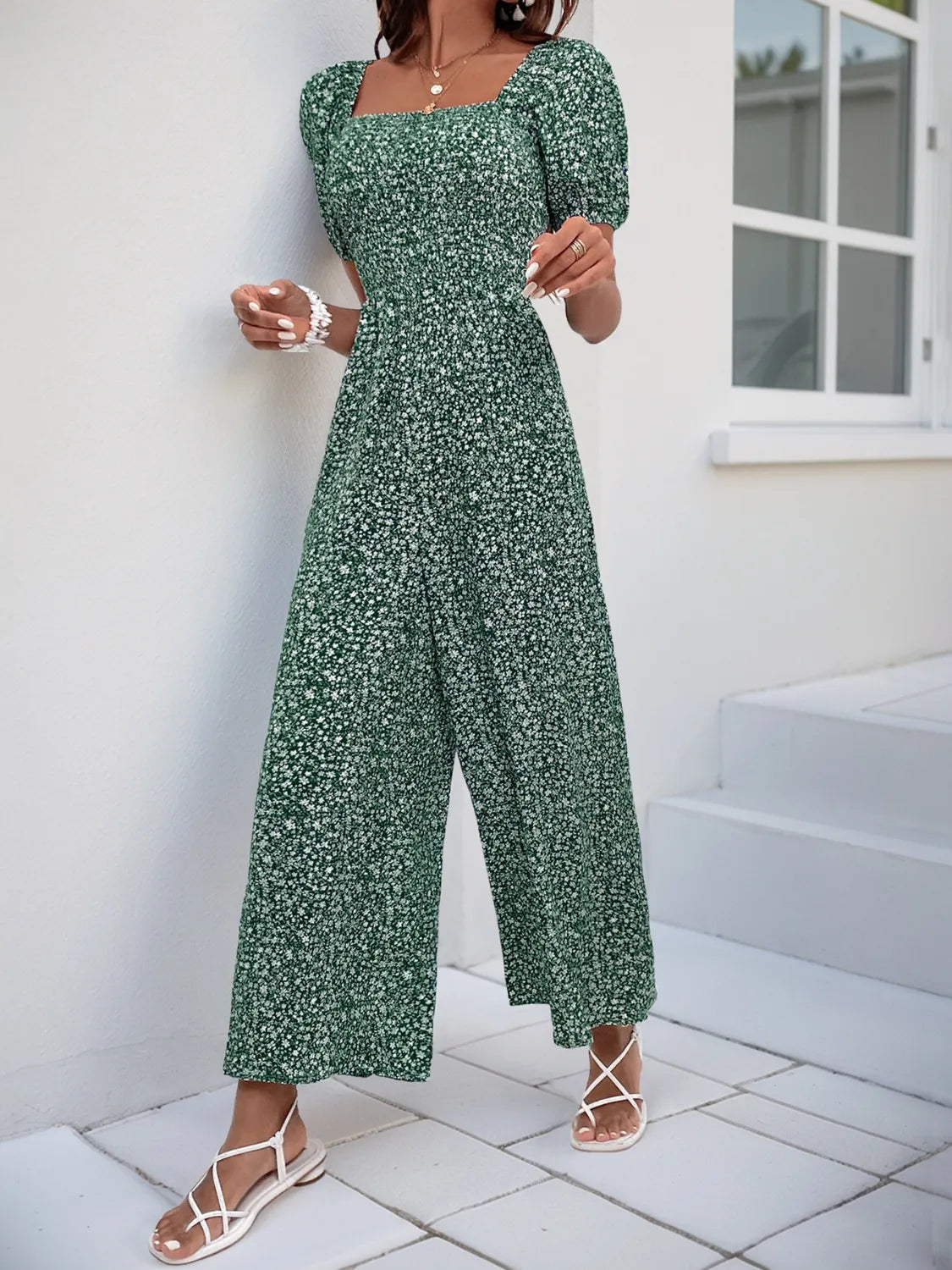 Dark Green floral smocked bodice jumpsuit with puff sleeves and wide legs.