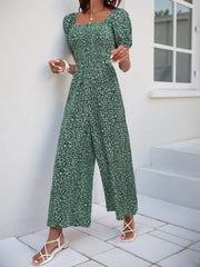 Dark Green floral smocked bodice jumpsuit with puff sleeves and wide legs.