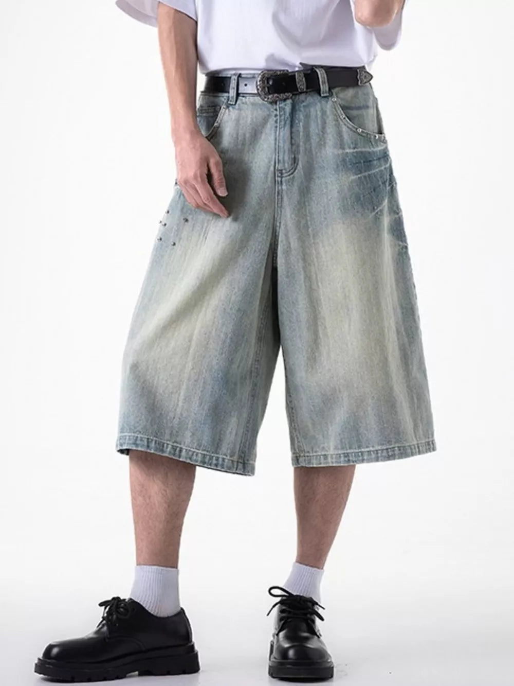 Relaxed fit light blue denim shorts with coin pocket and studded details.