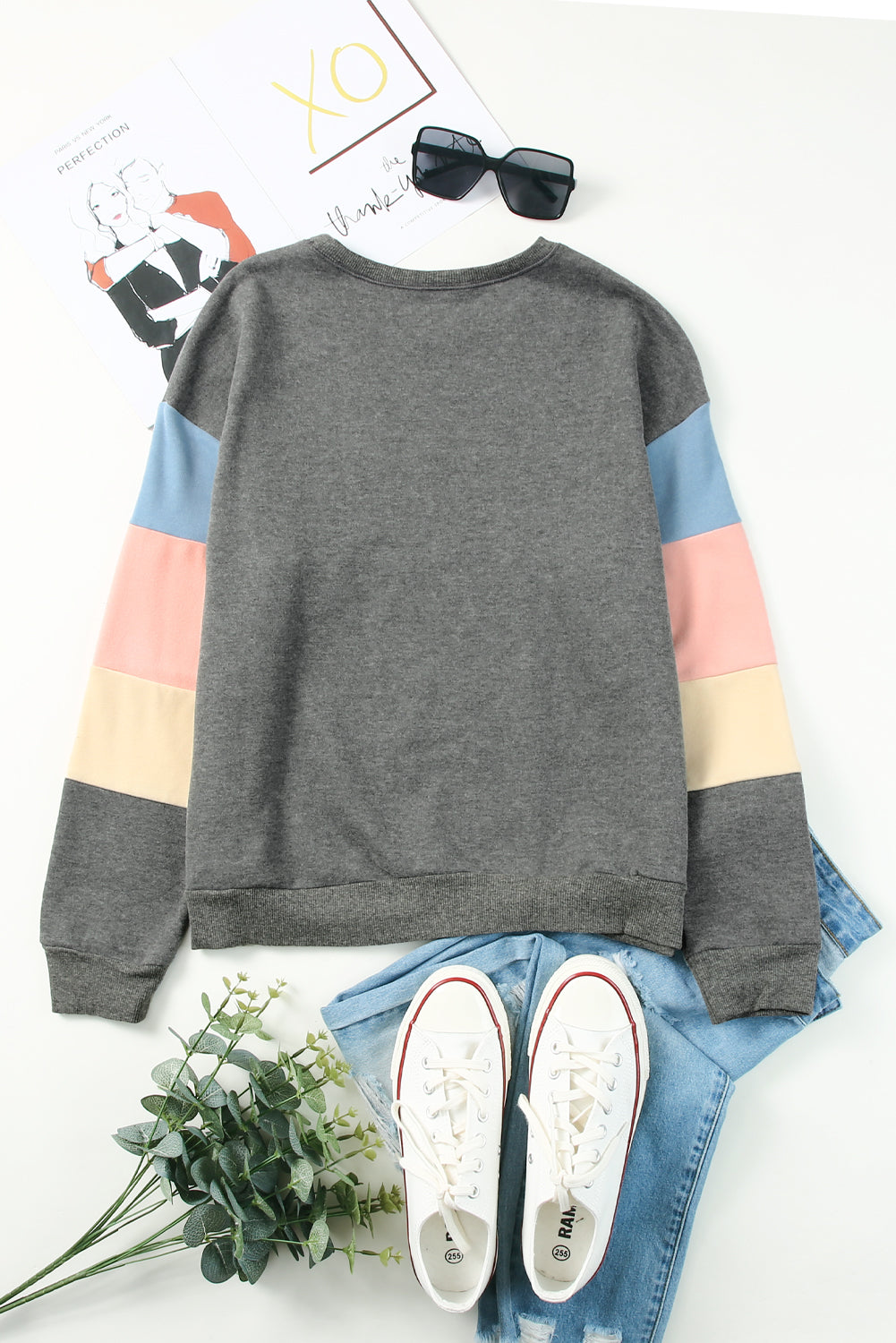 Gray crewneck sweatshirt with colorblock sleeves in pink, blue, and cream.