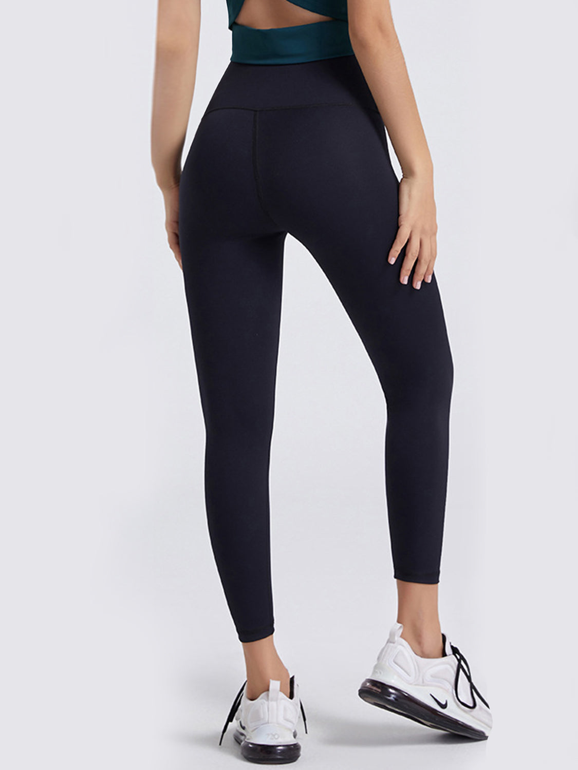 Black high-waist leggings with contouring seams.