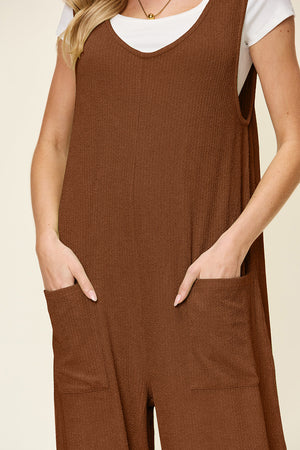 Caramel ribbed knit tie-strap jumpsuit with V-neck and side pockets.