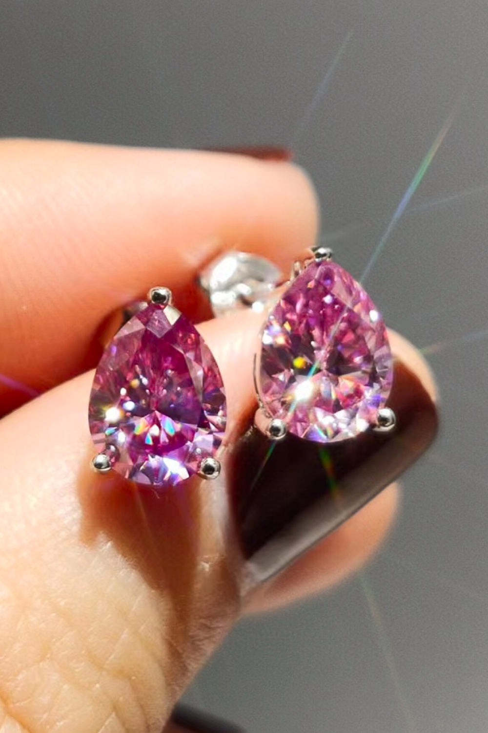Pink teardrop halo stud earrings in 925 sterling silver with sparkling cubic zirconia.