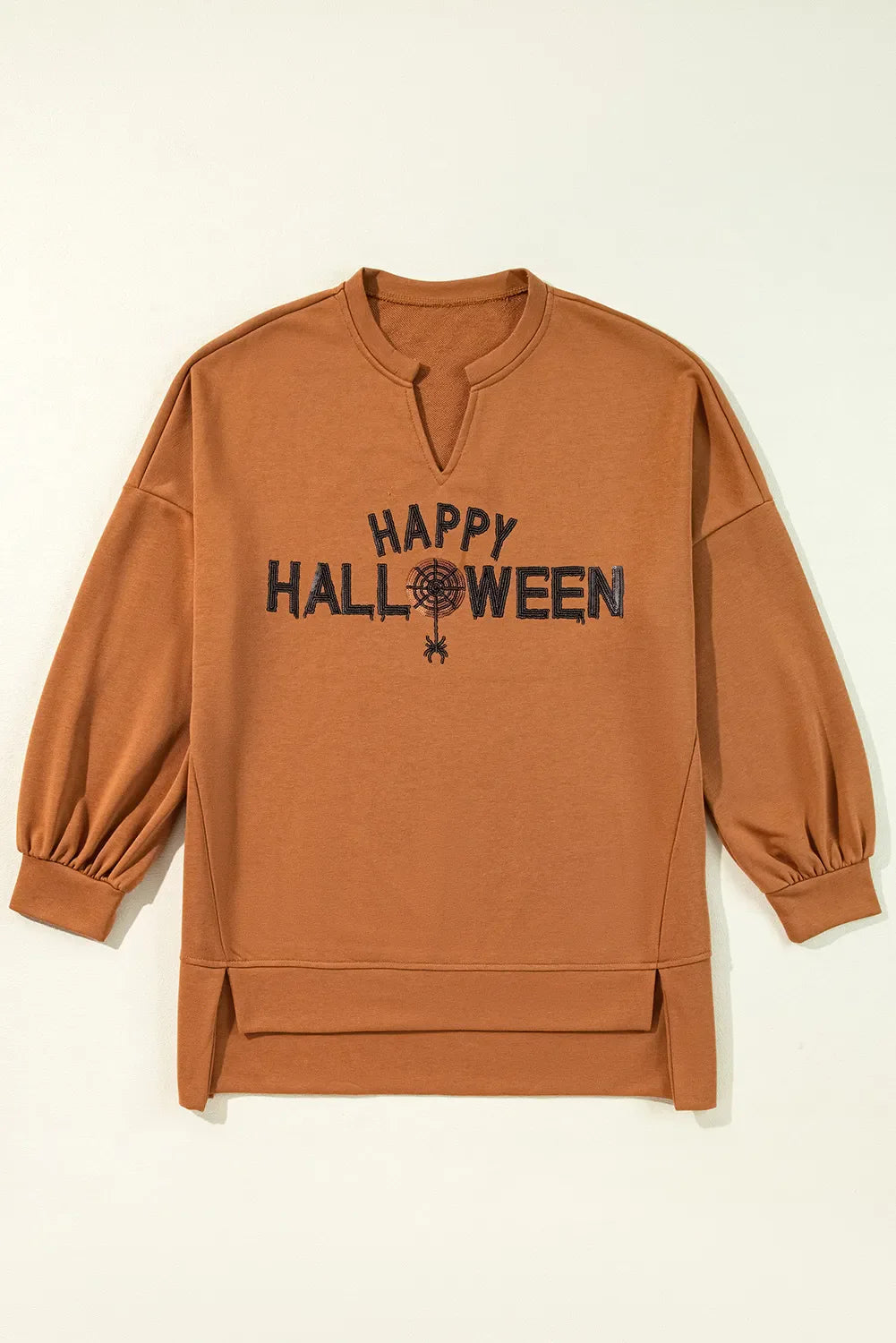 Caramel Halloween graphic slit hem sweatshirt with V-neck and balloon sleeves.