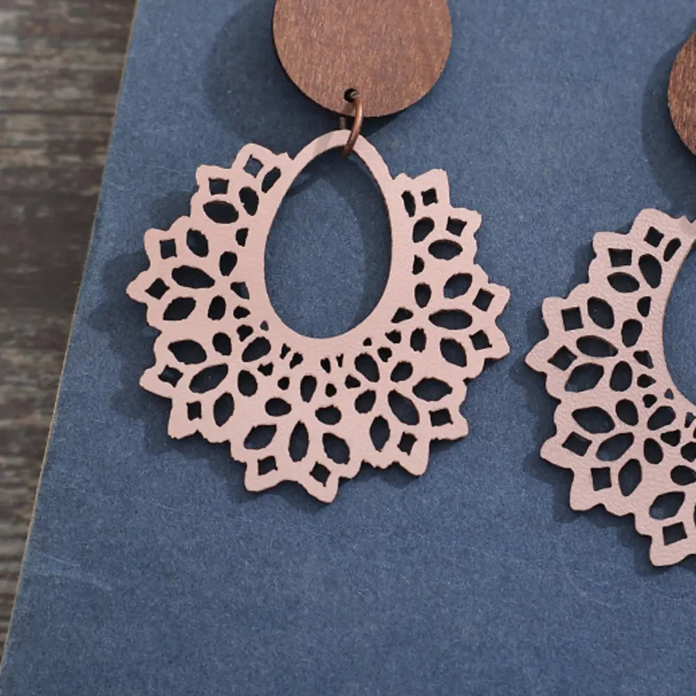 Floral laser-cut wooden drop earrings in Dusty Pink with intricate cutouts and a boho design.
