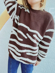 Brown acrylic crewneck sweater with textured white stripes.