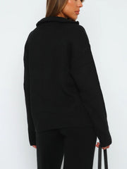Black ribbed knit quarter-zip loungewear set with a relaxed fit and high collar.