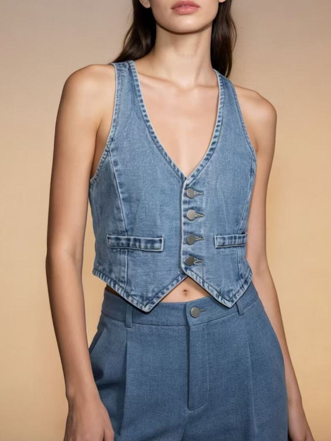 Light blue denim cropped vest with button-down front and pocket details