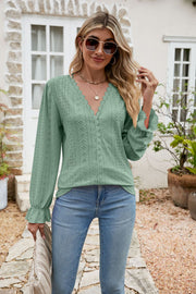 Light green eyelet lace blouse with V-neck and ruffle sleeves.
