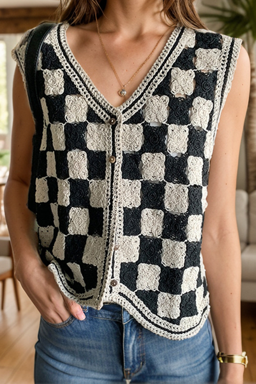 Checkerboard crochet vest with v-neck and button front in black and cream.