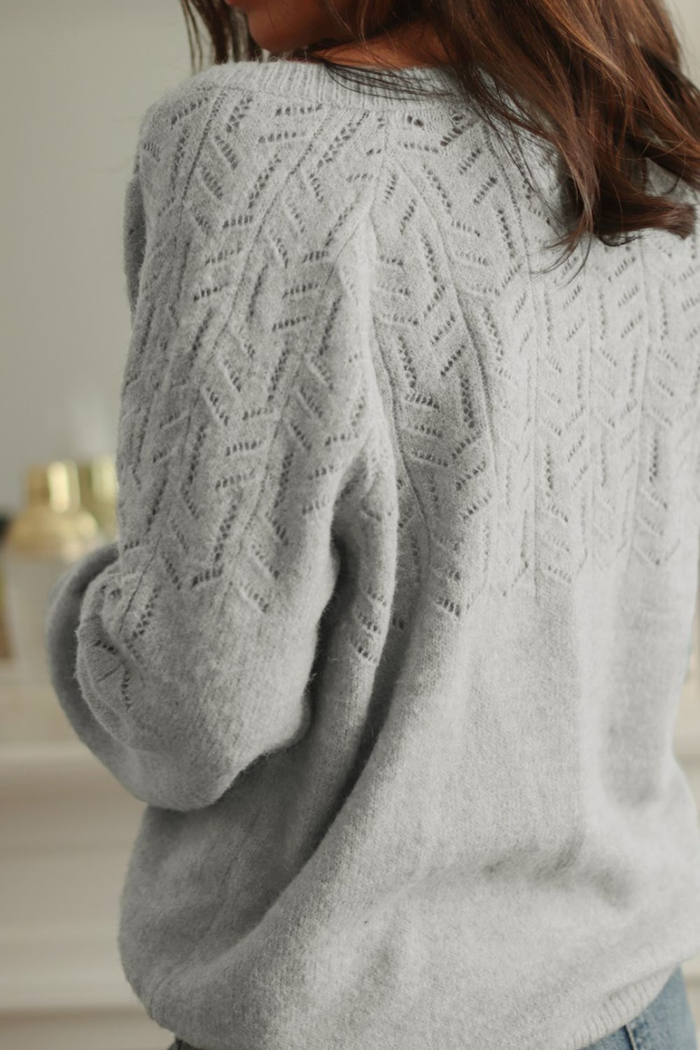 Gray lace-effect knit cardigan with chevron pattern detail on back and sleeves.