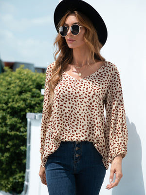 Beige dotted print blouse with balloon sleeves and V-neck.