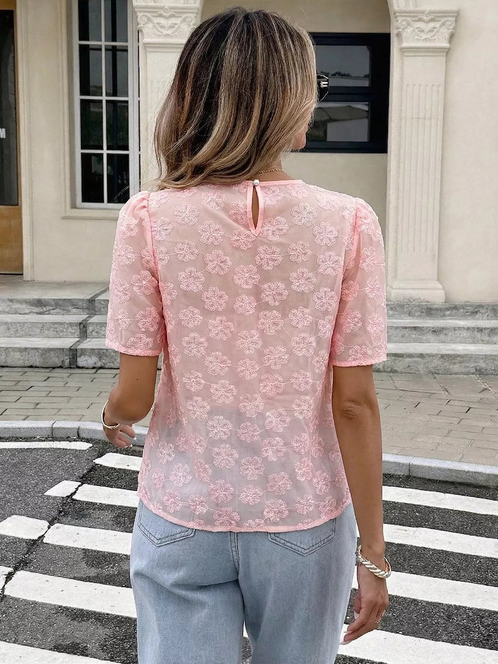 Pink embroidered floral sheer blouse with pearl trim detail and puff sleeves.