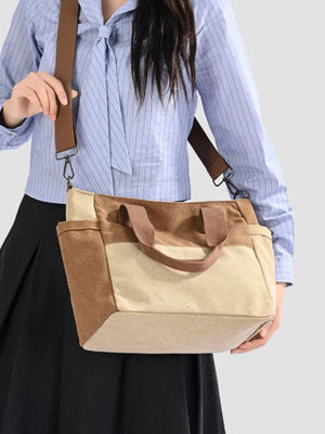 Multi-pocket canvas travel bag in taupe and tan with adjustable strap.