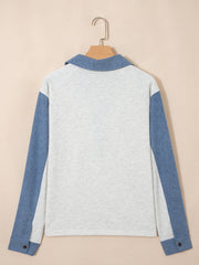 Heathered casual top with blue sleeves and button detail