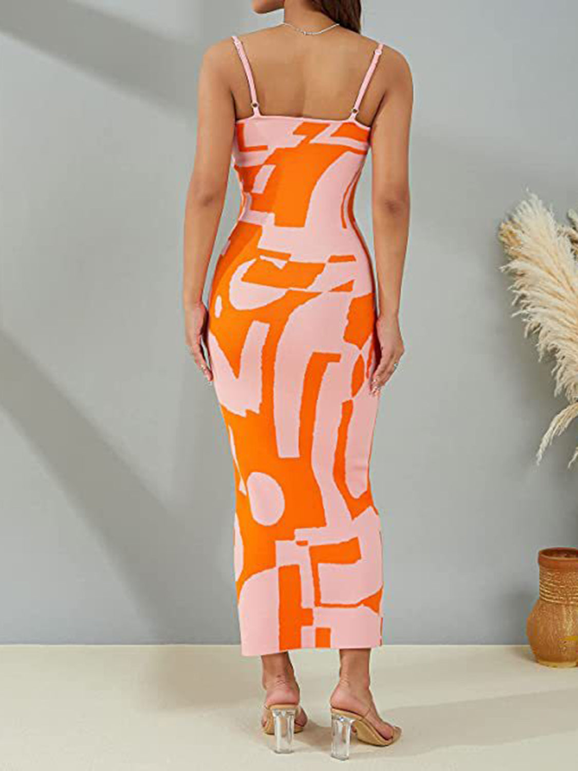Geometric knit maxi slip dress in orange and pink abstract print with spaghetti straps.