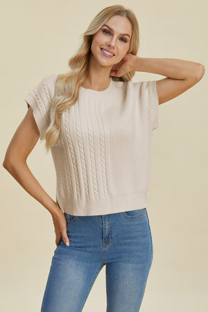 Beige cable knit cap sleeve pullover sweater with crew neck.