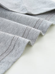 Grey cotton t-shirt detail showing hem stitching
