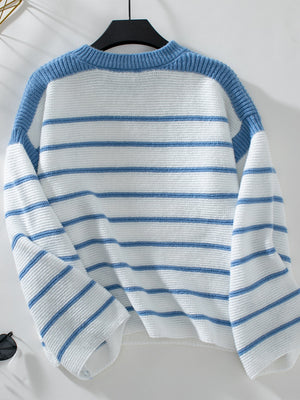 Blue and white striped knit sweater with wide sleeves and a crew neck.