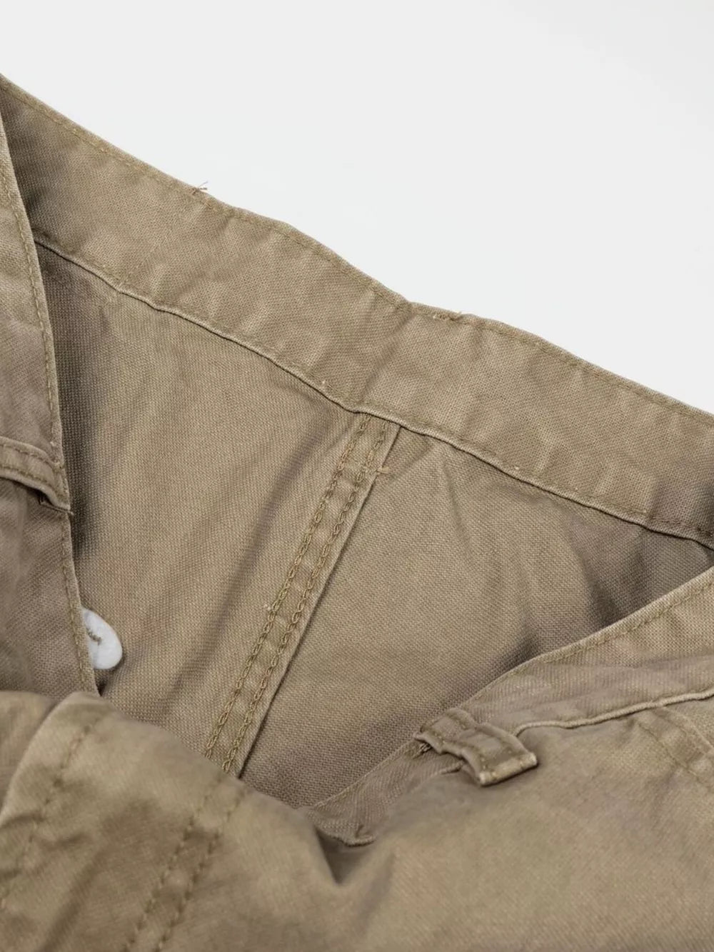 Khaki cargo pants with visible stitching and button closure detail.