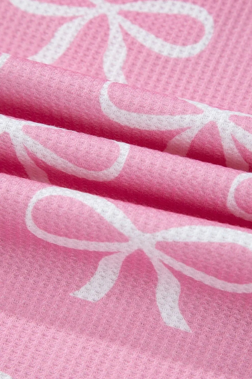 Pink ribbed loungewear set with white bow print detail