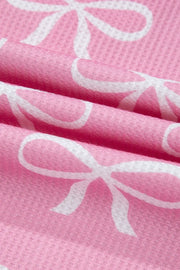 Pink ribbed loungewear set with white bow print detail