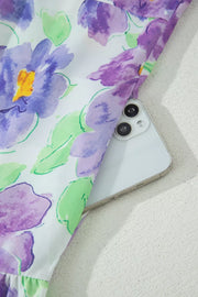 Mini dress with vibrant purple floral print and ruffled hem detail.