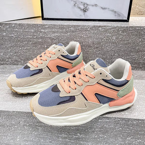 Panelled retro runner sneakers in beige, peach, blue, and green with white soles.