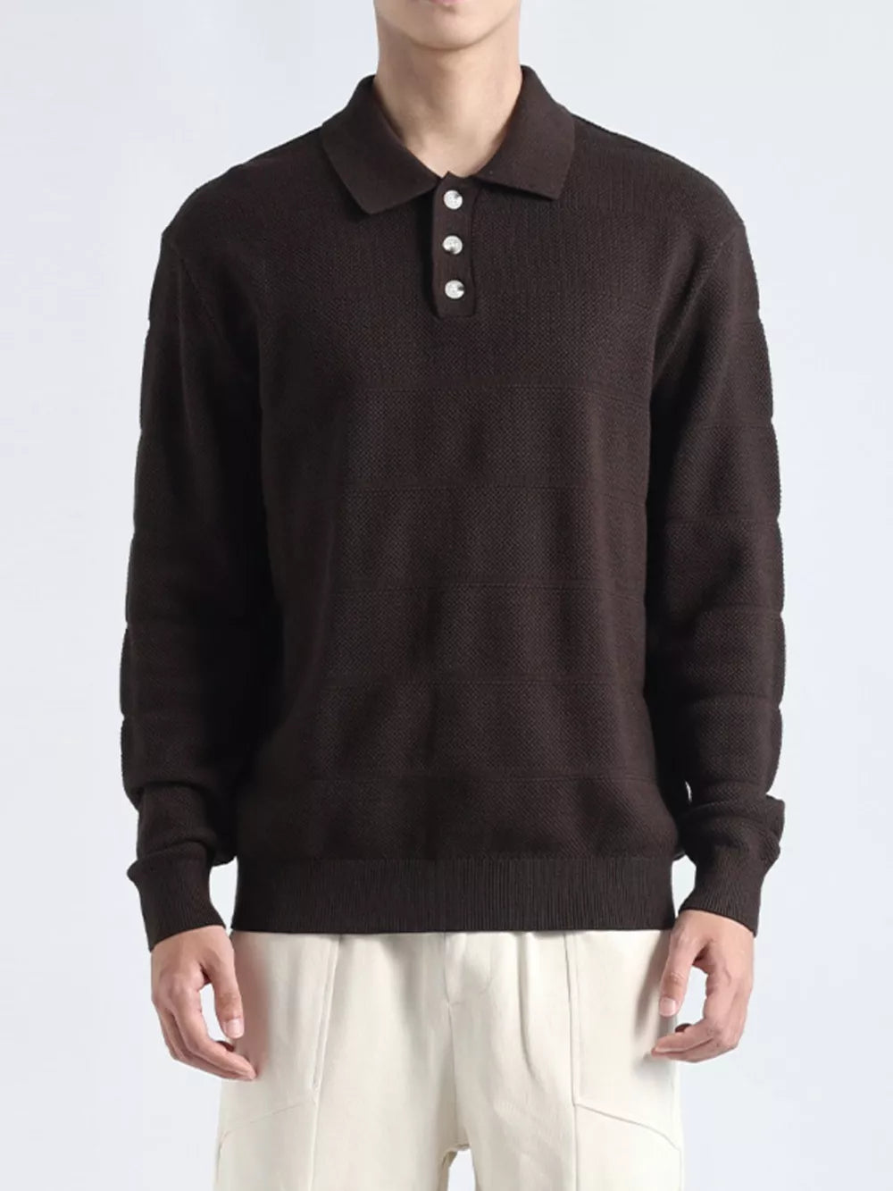 Brown knit polo shirt with button accents and textured pattern.