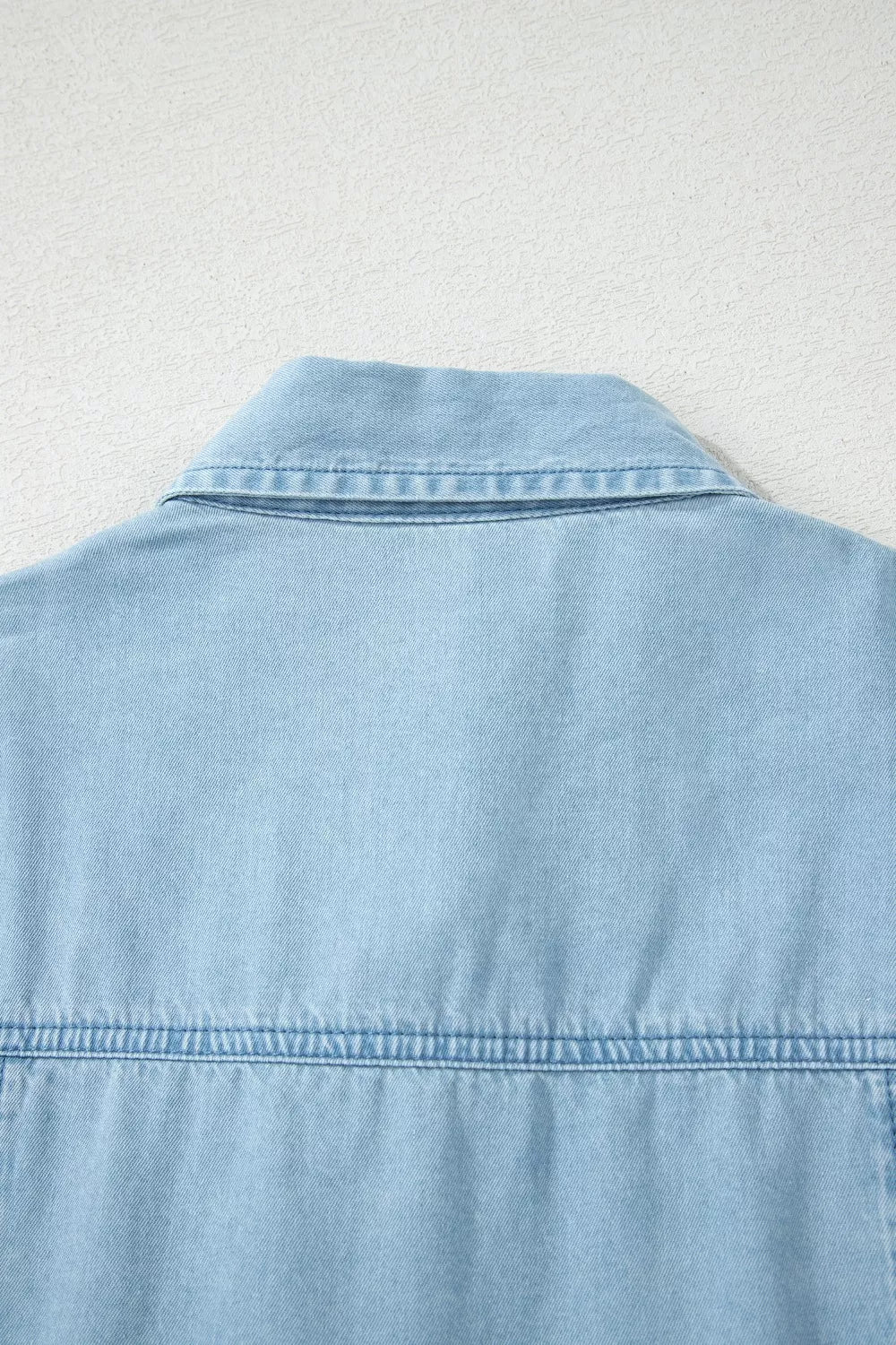 Light blue denim midi dress with collar and button details.