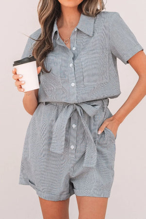 Pinstripe shirred waist romper with tie and short sleeves, featuring button front and chest pockets.