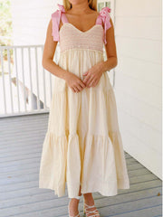 Cream tiered midi dress with smocked bodice and pink tie shoulder straps.