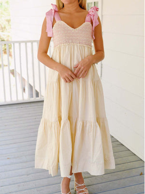 Cream tiered midi dress with smocked bodice and pink tie shoulder straps.